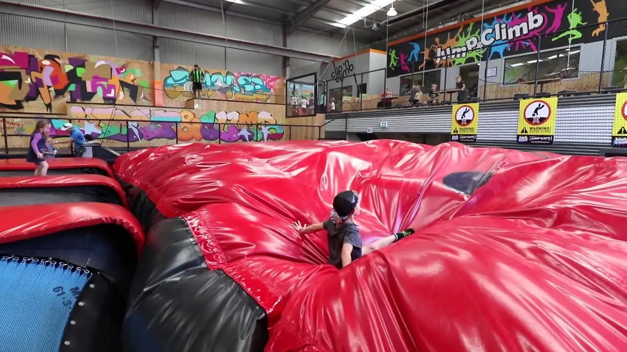 A visitor landing on the Jump & Climb airbag